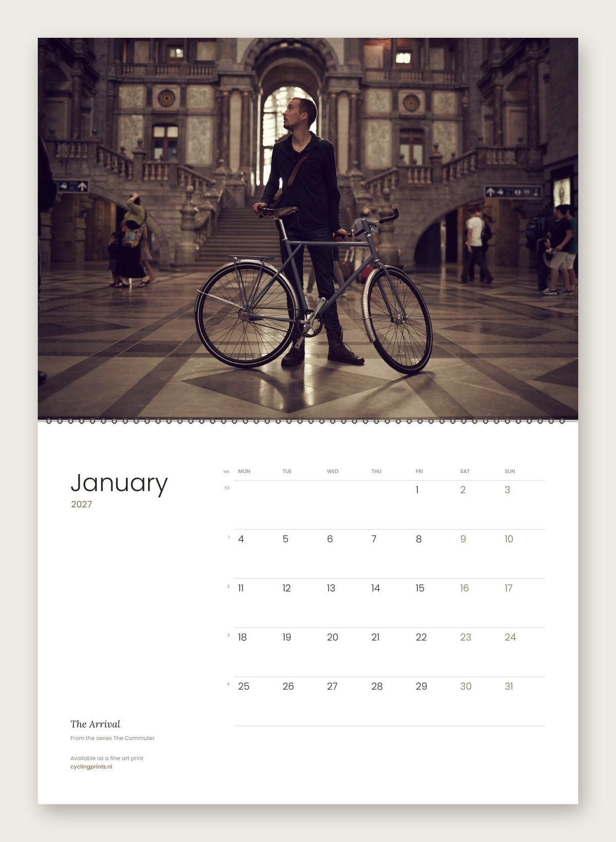 The Commuter 2027 cycling photography wall calendar by Ryan Edy – January, The Arrival, shown hanging