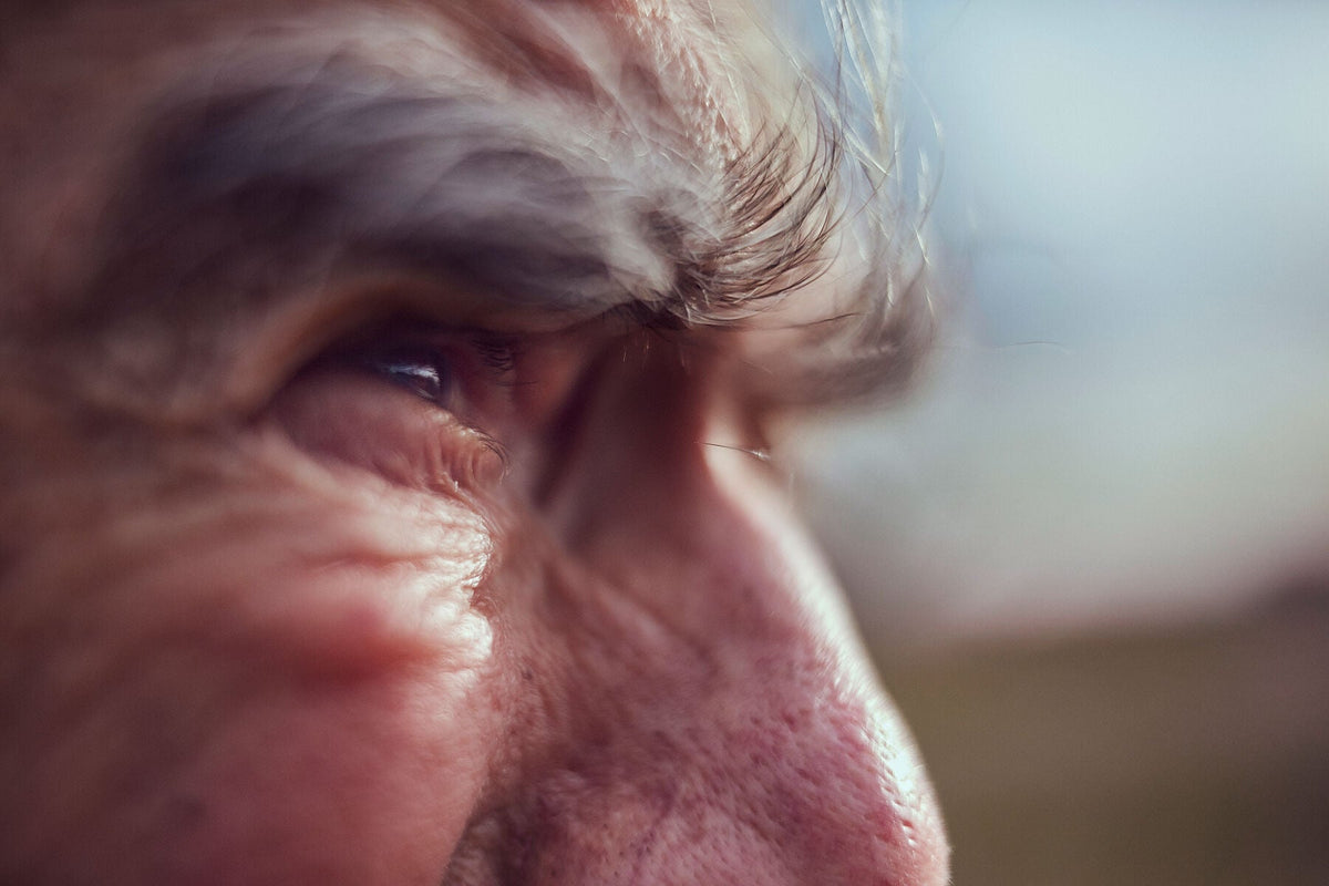 Dutch cycling photography 'Focus.  Albert, 82-Year-Old Endurance Cyclist,' - Albert, an 82-year-old cyclist, on his custom-built steel bike along the Waal and Lek river dikes, Netherlands, fine art print by Cyclingprints.nl