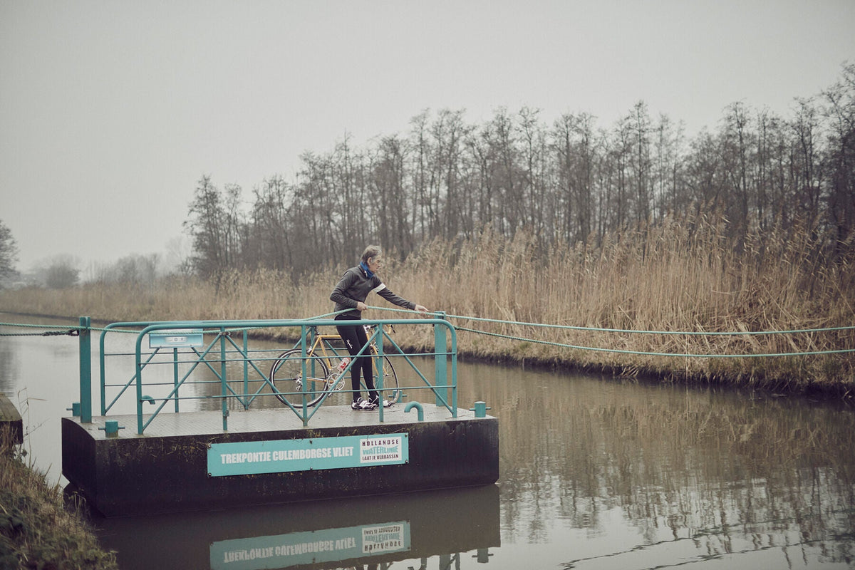Nederlandse Wielerfotografie 'Ropes&Hopes' - Albert, een 82-jarige wielrenner, op zijn op maat gebouwde stalen fiets langs de Waal- en Lekdijken, Nederland, fine art print door Cyclingprints.nl