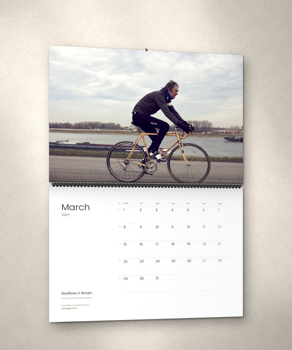 March 2027 – Backbone & Barges, a page from the A Man of Steel cycling photography wall calendar by Ryan Edy
