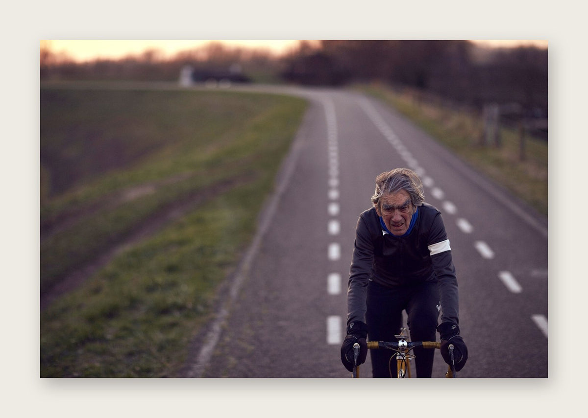 Between the Lines – A Man of Steel fine art cycling postcard by Ryan Edy