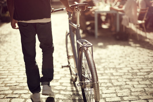 “Customs & Cobbles” Stylish commuter riding a city bike on cobbled streets, award-winning fine art cycling photography.
